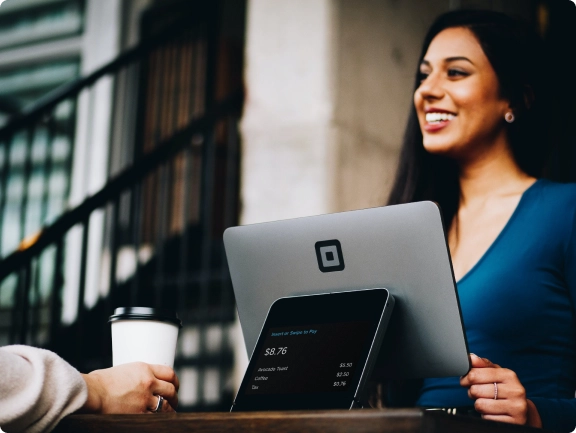 A photograph of a smiling and happy business owner interacting with a customer